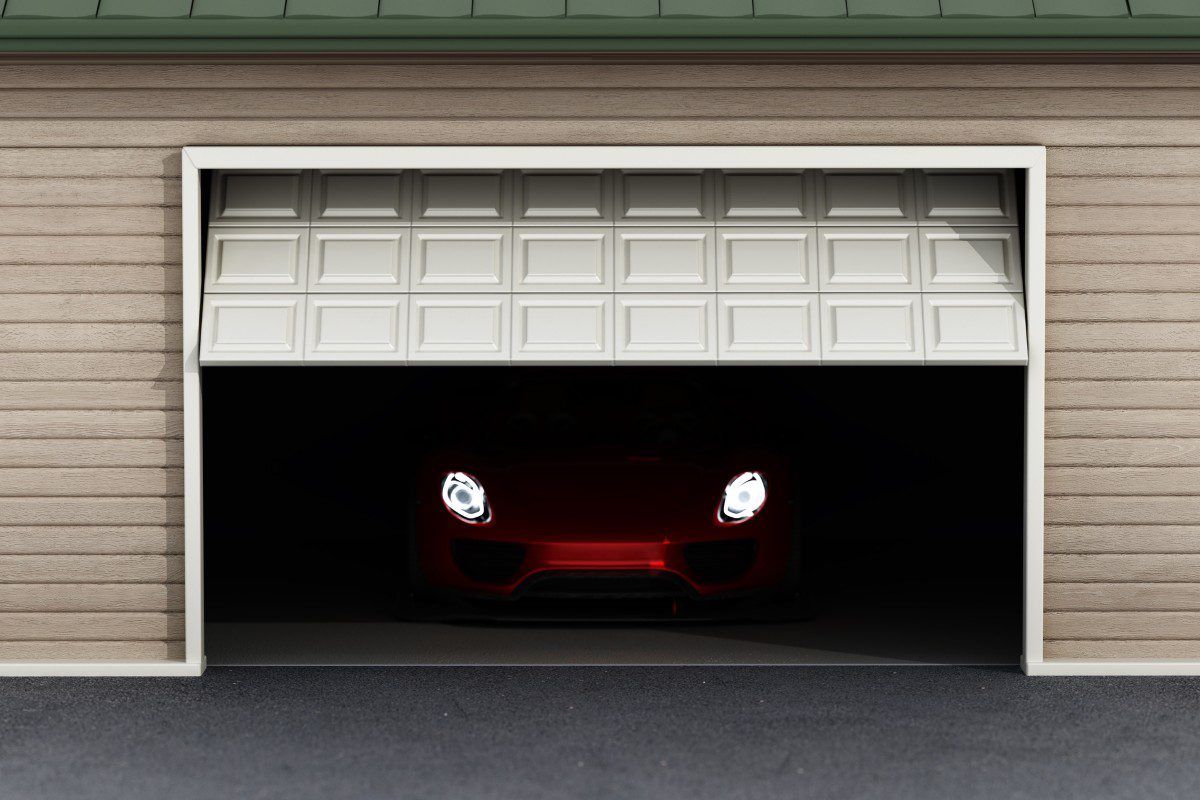 Red car headlights in dimly lit garage.